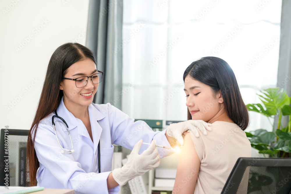Doctor doing vaccination on patient's shoulder, influenza vaccination on arm