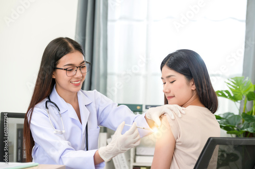 Doctor doing vaccination on patient's shoulder, influenza vaccination on arm