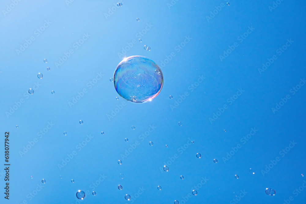 Soap bubbles in the blue sky. Beautifully iridescent balls of soap foam in the air Soap bubbles in the blue sky. Beautifully iridescent balls of soap foam in the air