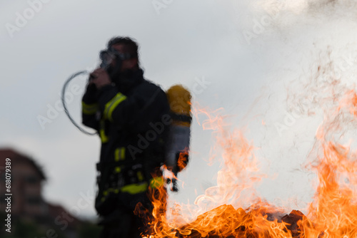 Portrait of a heroic fireman in a protective suit. Firefighter in fire fighting operation.