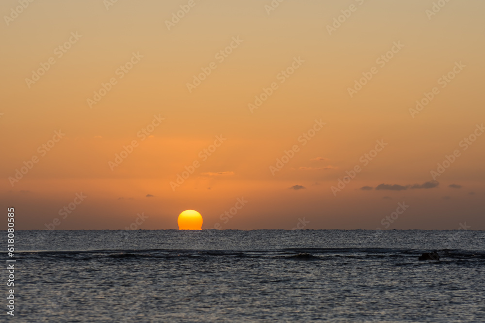 beautiful warm  sunrise with a distorted orange sun at the horizon from the red sea in egypt