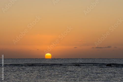 Fototapeta Naklejka Na Ścianę i Meble -  beautiful warm  sunrise with a distorted orange sun at the horizon from the red sea in egypt