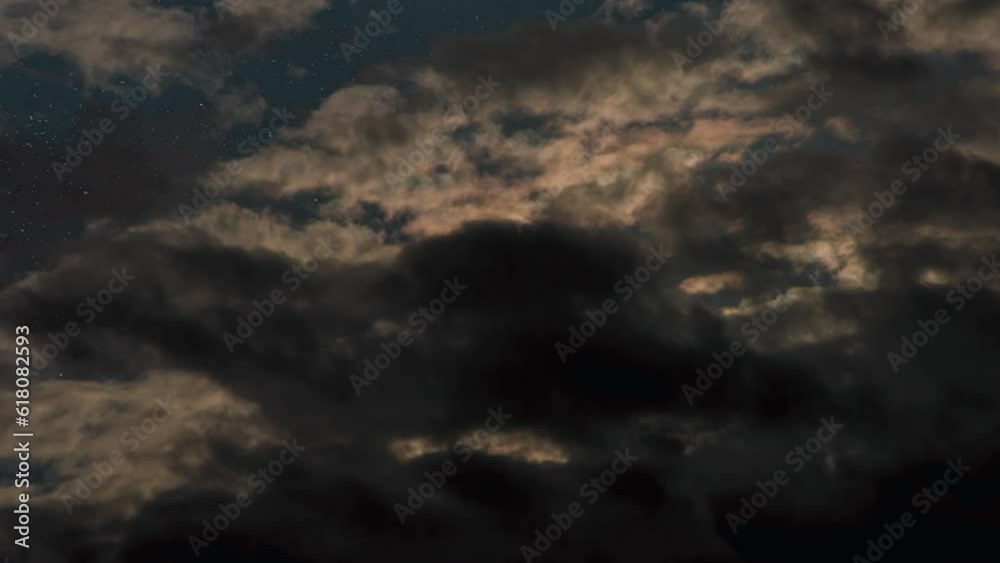 Clouds Cover the Starry Sky. Time-Lapse. The night starry sky is quickly covered by dense clouds illuminated by backlit moonlight