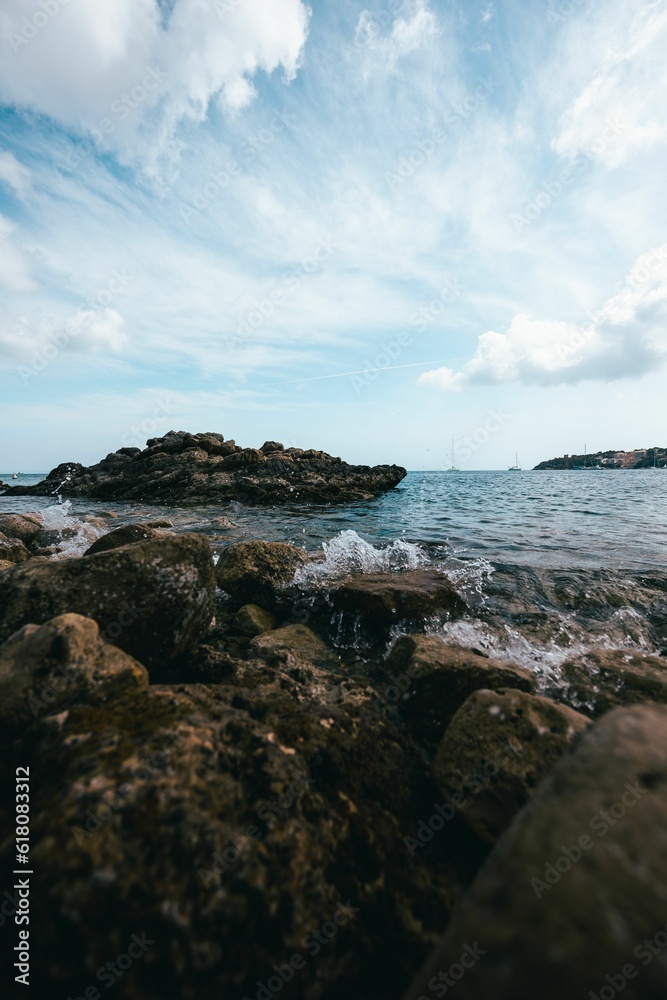 Stunning view of the ocean with its waves crashing against the rocks on a sunny day Stunning view of the ocean with its waves crashing against the rocks on a sunny day