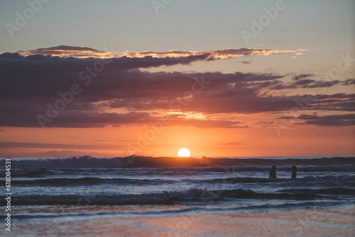 People are captured enjoying their activity during a beautiful sunset