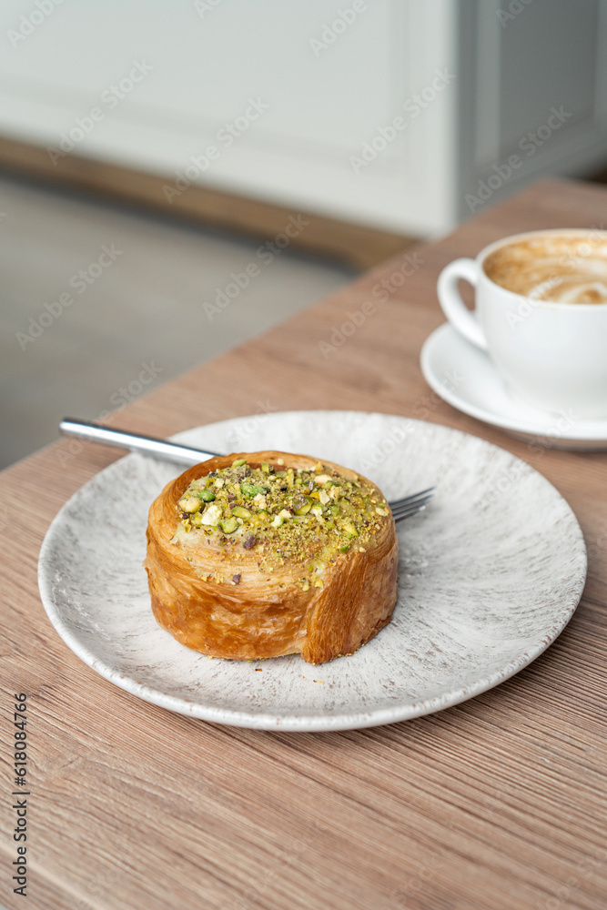Still life of round Croissants with Pistachio grain and coffee Still life of round Croissants with Pistachio grain and coffee