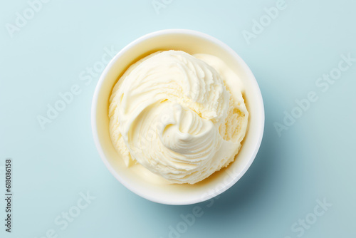 Top view of delicious vanilla milk ice cream in a round white vase isolated on a light pastel blue background. Copy space for text. Generative AI photo.