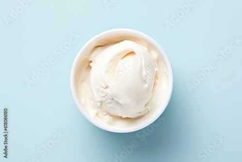 Overhead view of delicious vanilla milk ice cream in a round white vase isolated on a light pastel blue background. Copy space for text. Generative AI photo.