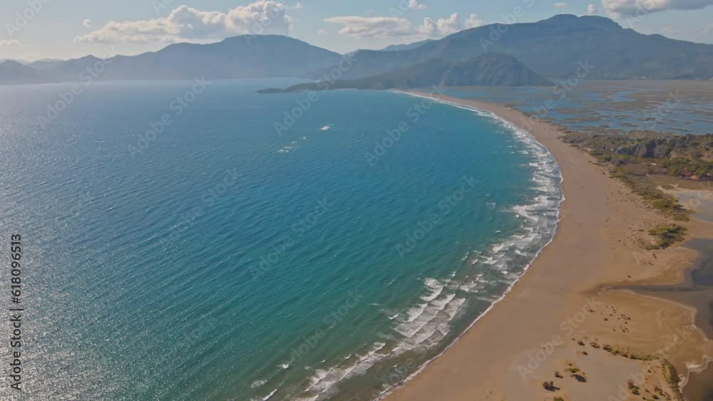 Tropical sandy Iztuzu Turtle beach and calm blue sea,Turkey. Natural seamlessly loopable clip of the tropical empty beach with infinite rolling waves. Tropical sandy Iztuzu Turtle beach and calm blue sea,Turkey. Natural seamlessly loopable clip of the tropical empty beach with infinite rolling waves.