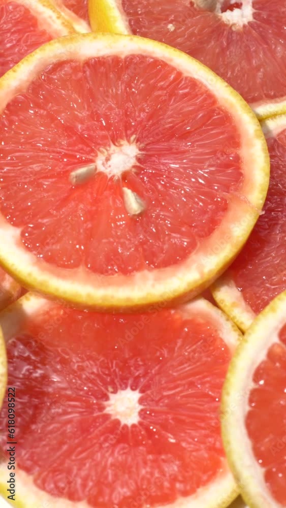 Vertical shot of tasty ripe grapefruit slices Vertical shot of tasty ripe grapefruit slices