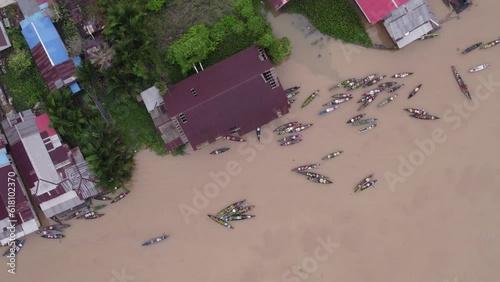 Top down of famous Floating market at Banjarmasin on brown river, aerial photo