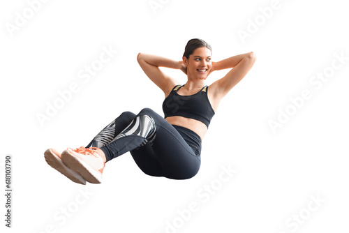 Attractive slim girl in sportswear is doing crisscross exercise, bicycle crunches pose, on the floor on a transparent background. Healthy lifestyle.