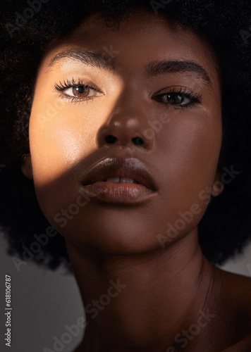 Shadow, portrait and black woman with beauty light, natural facial makeup and aesthetic skincare shine. Creative studio lighting, cosmetology and African person face with self care on grey background