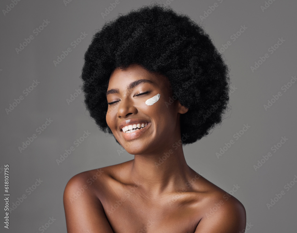 African woman, beauty cream and studio with afro, skincare and cosmetics by grey background. Girl, happy model and healthy with natural glow on skin with makeup, clean aesthetic and product for face