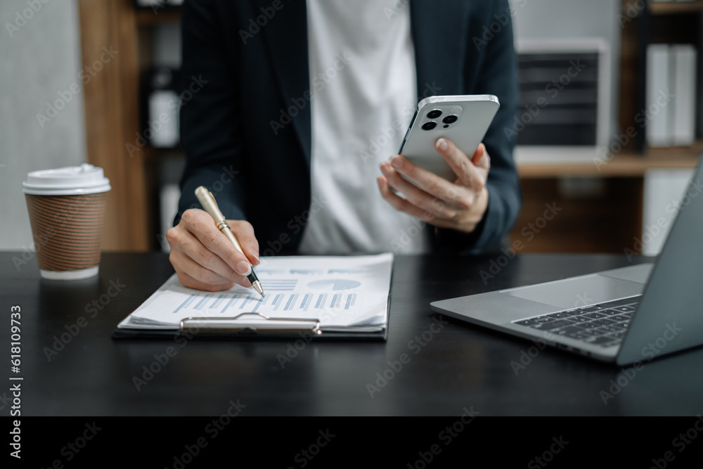 Business women calculate and analyzing graph document financial with laptop in office. Business women calculate and analyzing graph document financial with laptop in office.