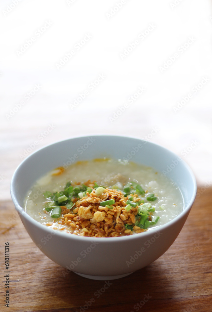Congee in a bowl with fried garlic and onion Congee in a bowl with fried garlic and onion