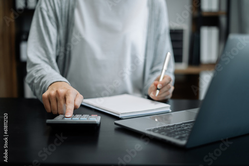 Businessman calculating monthly office expenses, taxes, bank account balance and credit card bills payment, Income is not enough for expenses in office.