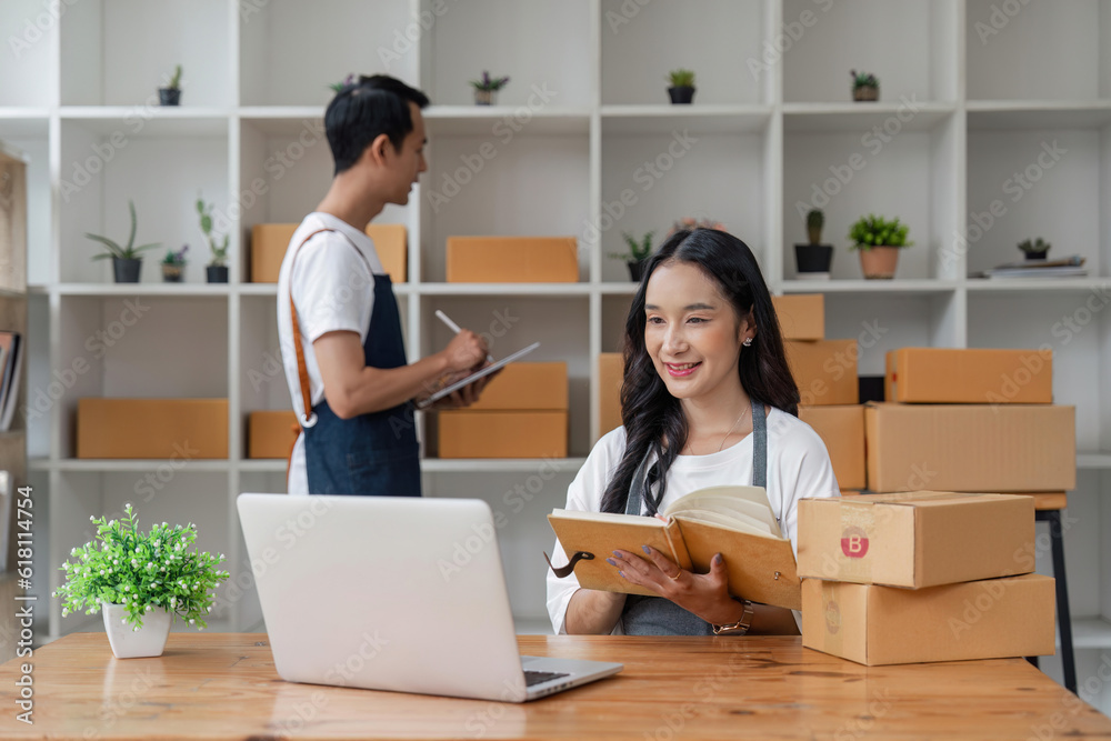 Couple working online with laptop computer and success to selling product online at home office Couple working online with laptop computer and success to selling product online at home office