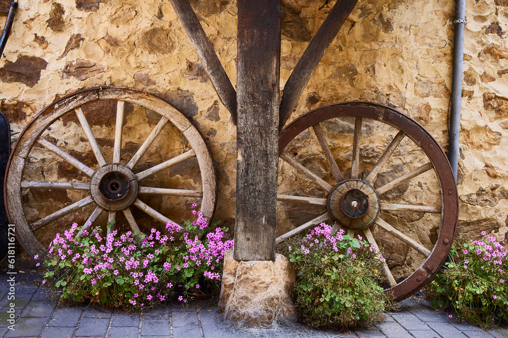 Rustic house. Shed of a rustic house. It is made of wood and has two wagon wheels. Rustic house. Shed of a rustic house. It is made of wood and has two wagon wheels.