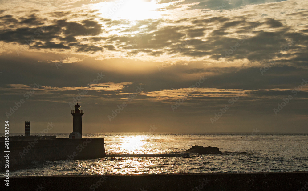 Lighthouse and sunset on the coast of Porto, Portugal