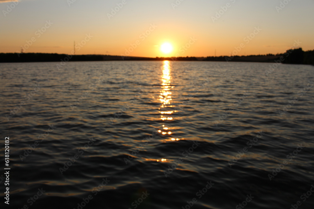 A body of water with a sunset