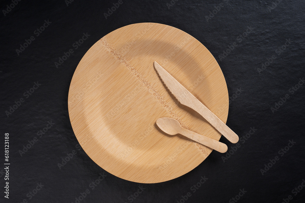 top view bamboo plate and cutlery. black background top view bamboo plate and cutlery. black background