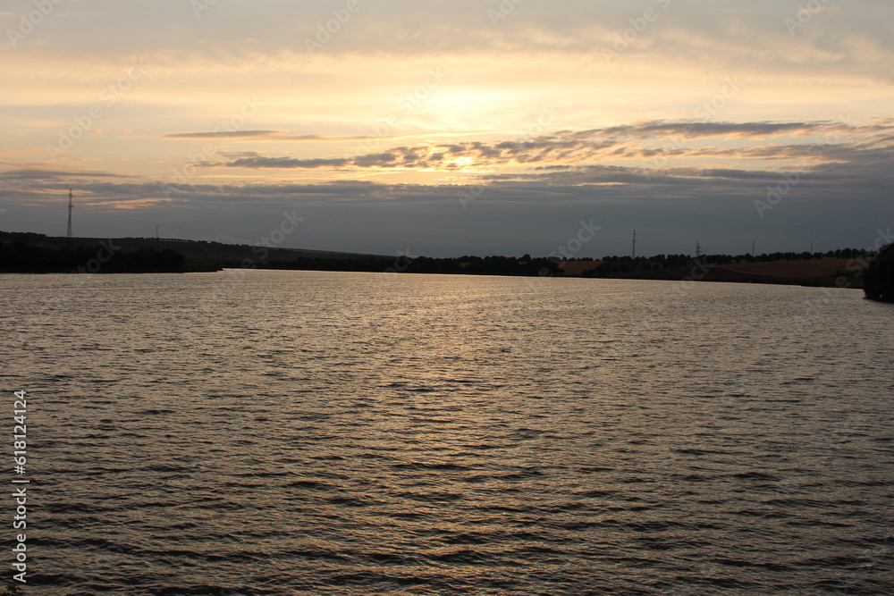 A body of water with a bridge in the background A body of water with a bridge in the background