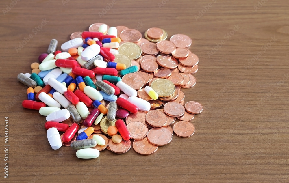 Medicines and coins. Concept of health care expenditure.