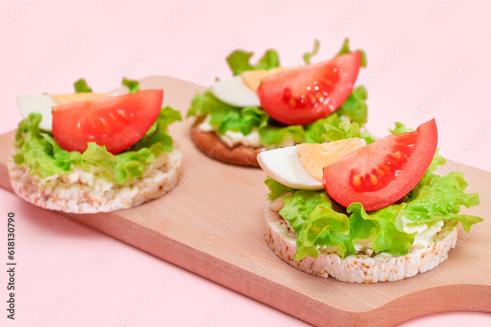 Rice Cake Sandwiches with Tomato, Lettuce and Egg on Wooden Cutting Board. Easy Breakfast. Diet Food. Quick and Healthy Sandwiches. Crispbread with Tasty Filling. Healthy Dietary Snack Rice Cake Sandwiches with Tomato, Lettuce and Egg on Wooden Cutting Board. Easy Breakfast. Diet Food. Quick and Healthy Sandwiches. Crispbread with Tasty Filling. Healthy Dietary Snack