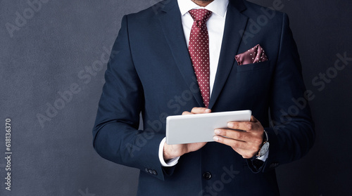 Closeup, business man or tablet in studio on mockup space of trading, planning or research on stock market website. Corporate trader, businessman and suit with digital technology of online investment