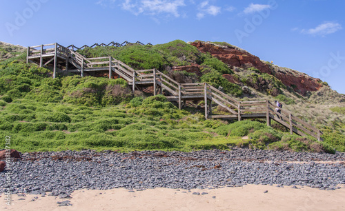 Wooden stairs to the beach by the ocean
