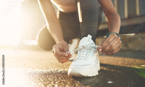 Tie, street or hands of person with shoelace for fitness training, exercise or running workout on road. Lace, zoom or leg of sports athlete with footwear ready to start exercising on ground in city photo