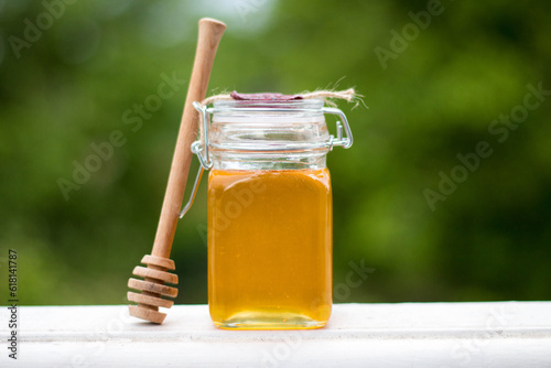 jar of honey with honey spoon