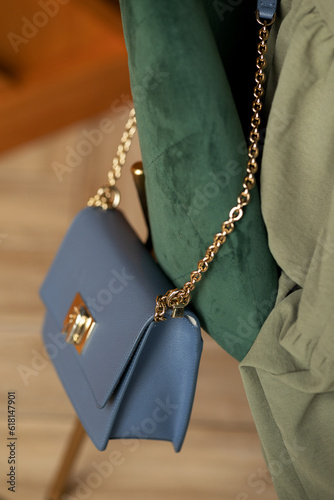 Blue female clutch on a green chair