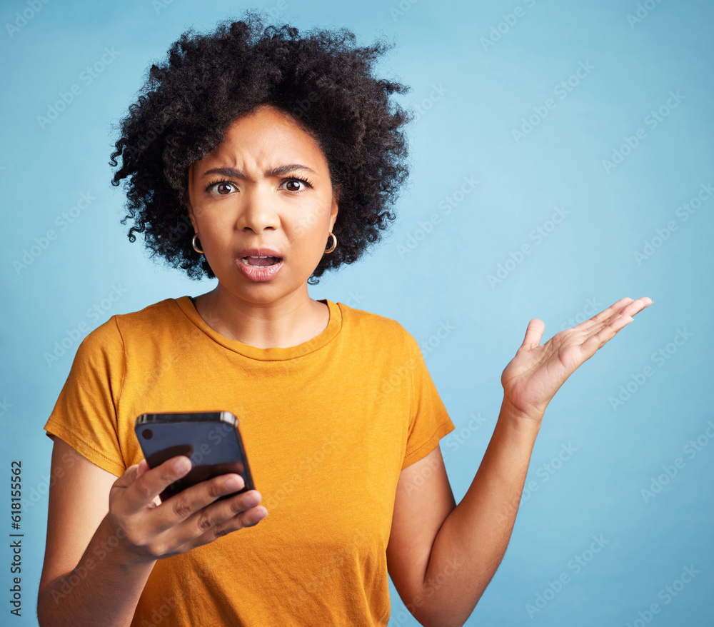 Confused, phone and woman portrait isolated on blue background for college doubt, decision or questions. Stress, surprise and young person or student in what or why hand for mobile problem or choice Confused, phone and woman portrait isolated on blue background for college doubt, decision or questions. Stress, surprise and young person or student in what or why hand for mobile problem or choice