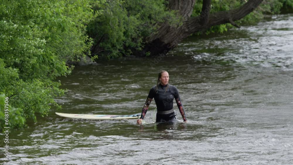 Woman athlete - Surfing on a river wave Woman athlete - Surfing on a river wave