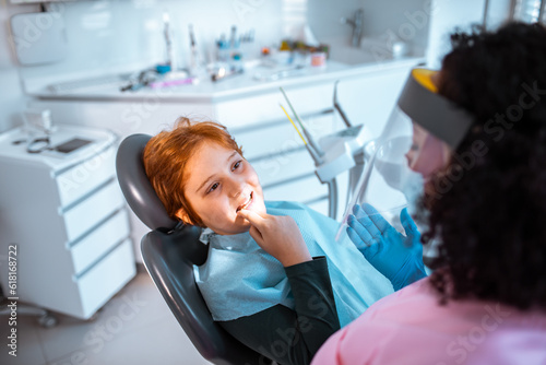 Young boy in a dental office having a female dentist work on his teeth