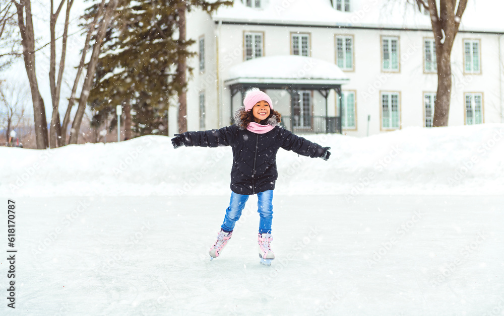 little girl skater in a winter park having fun