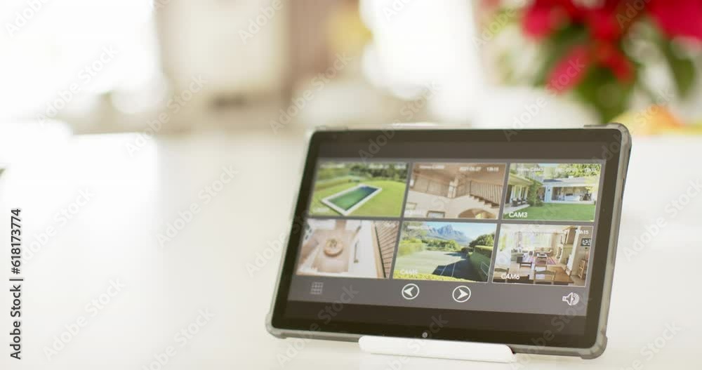 Close up of a tablet with home security camera views seen on screen Close up of a tablet with home security camera views seen on screen