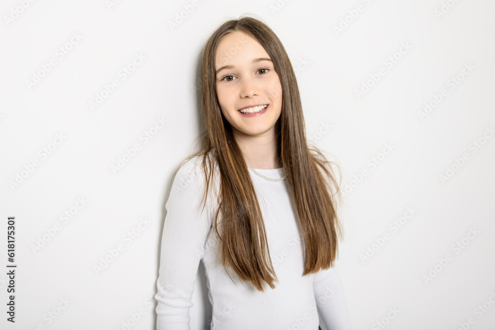 Young brunette pre teen girl on studio white Young brunette pre teen girl on studio white