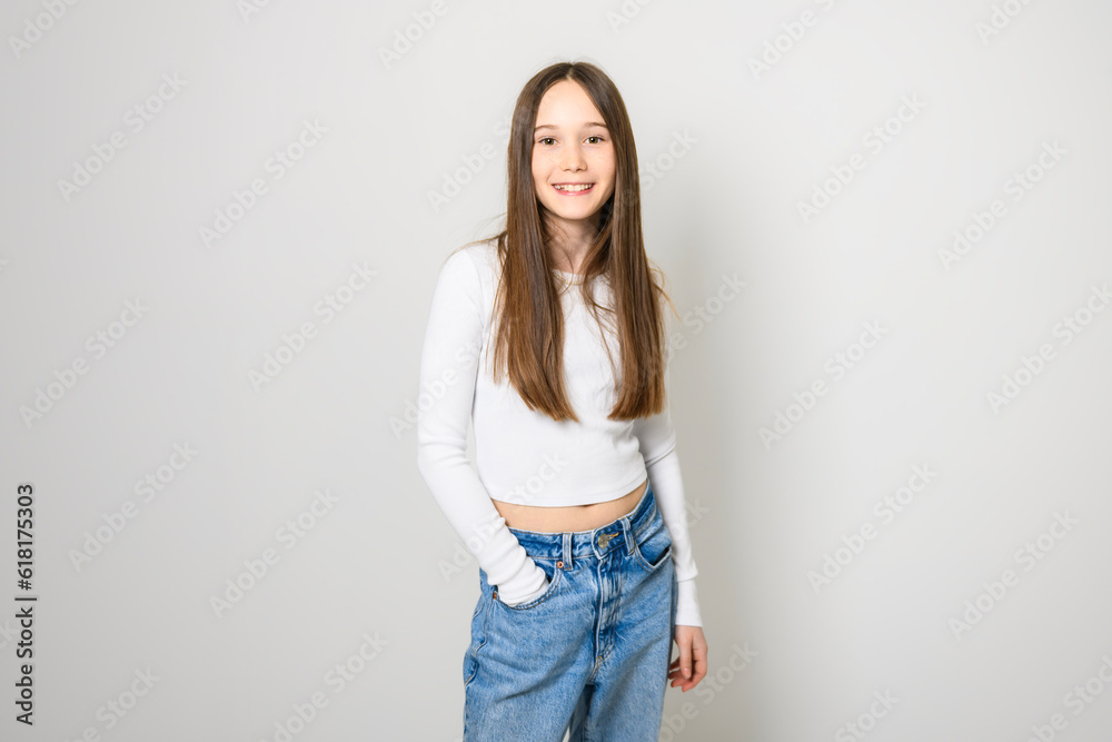 Young brunette pre teen girl on studio white Young brunette pre teen girl on studio white