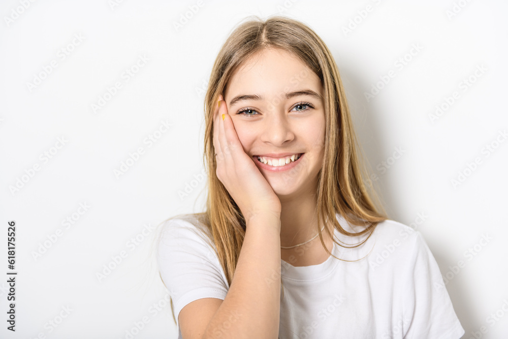 teenage girl in white shirt on a wall background teenage girl in white shirt on a wall background