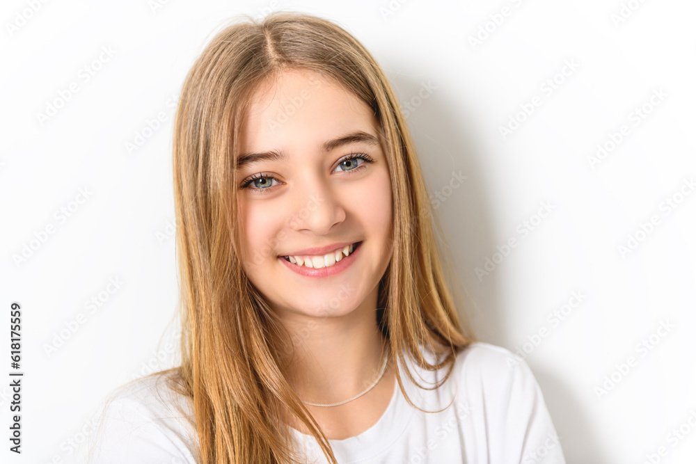 teenage girl in white shirt on a wall background teenage girl in white shirt on a wall background