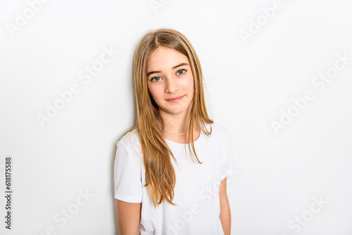 teenage girl in white shirt on a wall background