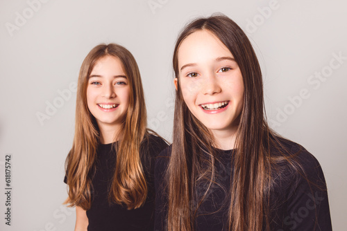 Two Young pre teen best friend girl on studio white