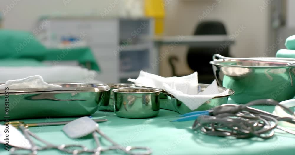 Close up of surgical instruments on table in operating theatre at hospital, slow motion