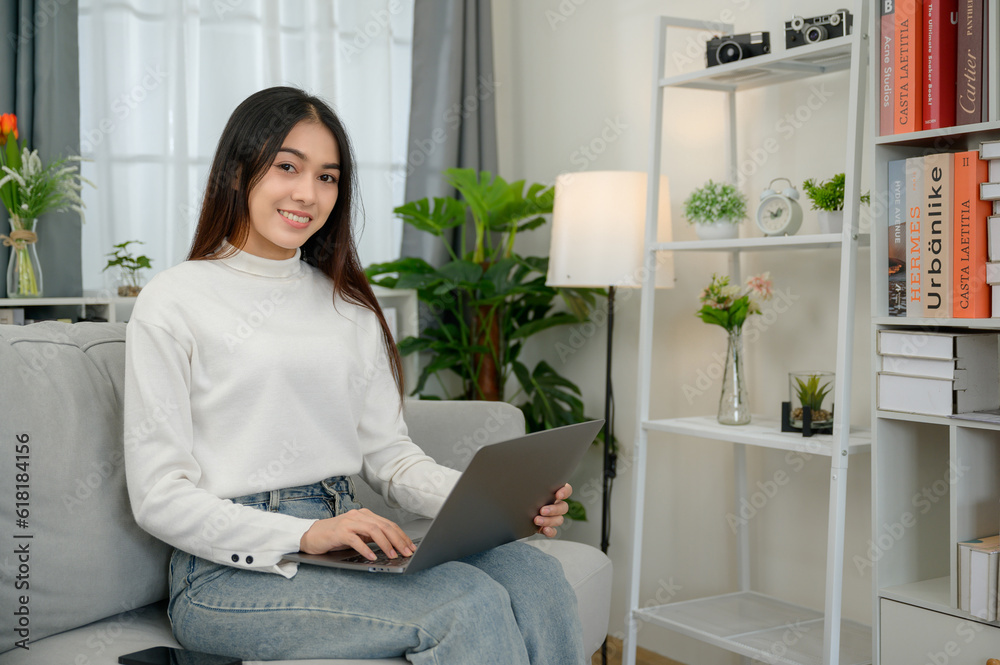 asian girl happy freelancer smiling looking at camera Have a laptop to work at home asian girl happy freelancer smiling looking at camera Have a laptop to work at home