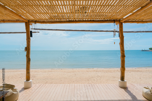 Fototapeta Naklejka Na Ścianę i Meble -  Wooden terrace with roof boho style on the beach in tropical sea
