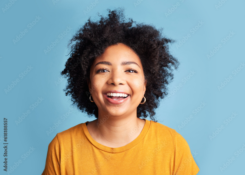 Happy, woman and portrait with natural beauty, confidence or smile with makeup on studio blue background. Face, happiness and person with African hair, afro or cosmetics to care for hairstyle