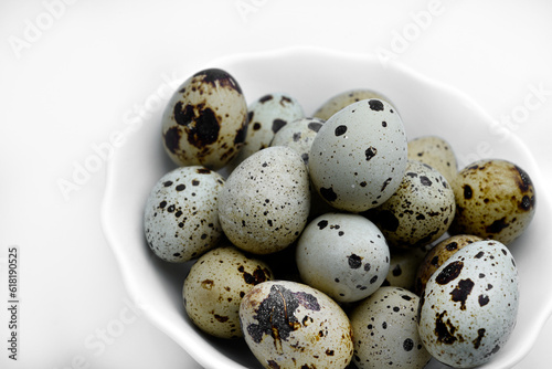 Quail eggs in a white plate. Food eggs on a white background.